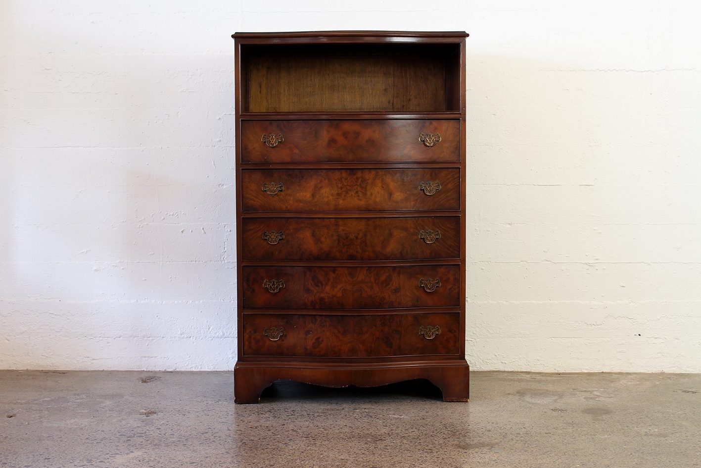 Curved walnut chest with shelf