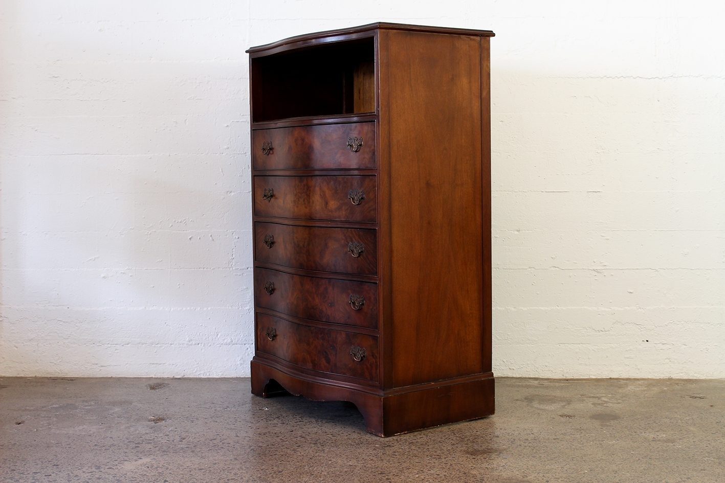 Curved walnut chest with shelf