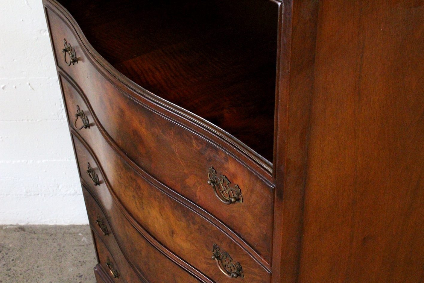 Curved walnut chest with shelf